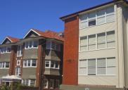 , These neighbouring buildings in Hayes Street, Neutral Bay, are similar in scale and function but show the dramatic change in design over 50 years of flat development. 'Kcot Sedar', on the left, was built in 1913 using the materials typical of the English Revival/Federation era. Though they represented a very modern way of living, these flats would have blended in with the existing housing stock. The block on the right was designed in 1958 and completed by EV Campbell Pty Ltd in 1960. The building demonstrates Modernism's rejection of decoration and typifies the post-war transformation of the suburb. Photograph by Ian Hoskins, 2013