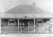 , 'Grace Cottage', shown here in the 1880s, exemplifies the vernacular timber Georgian house. It was transported across the Harbour and reassembled at 137 Mount Street by Thomas Thrussell in the 1870s or 1880s. The right hand side of the verandah was later enclosed to create a display window for fancy goods. The cottage remained in the family until the late 1920s when it was resumed and demolished during Sydney Harbour Bridge work. Stanton Library